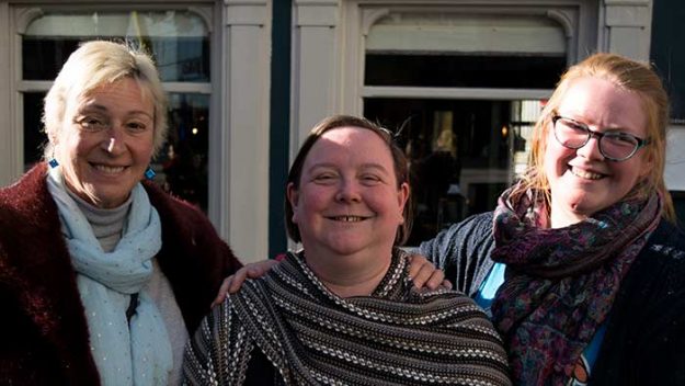 Three women standing next to each other