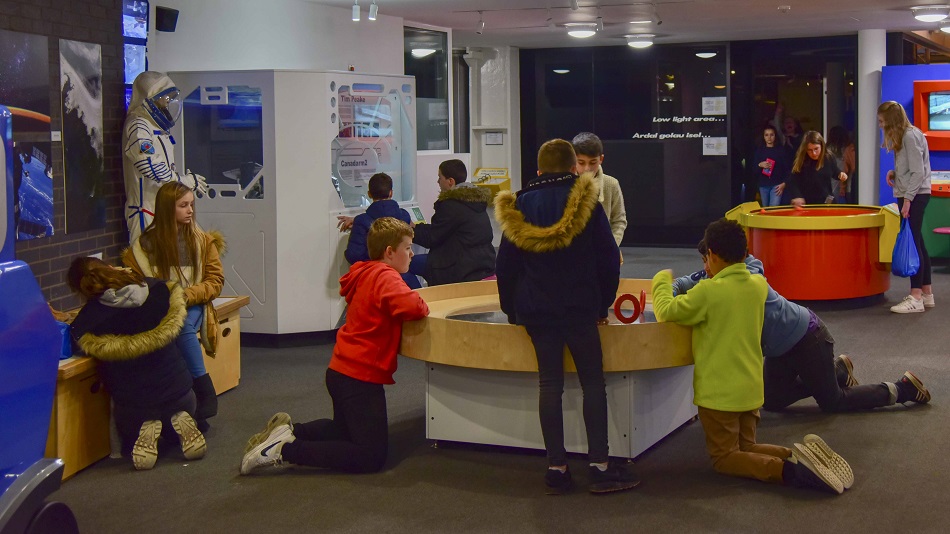 Children playing with interactive exhibits 