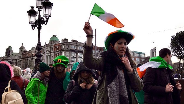 A woman waves an Irish flag during St Patrick's Day celebrations