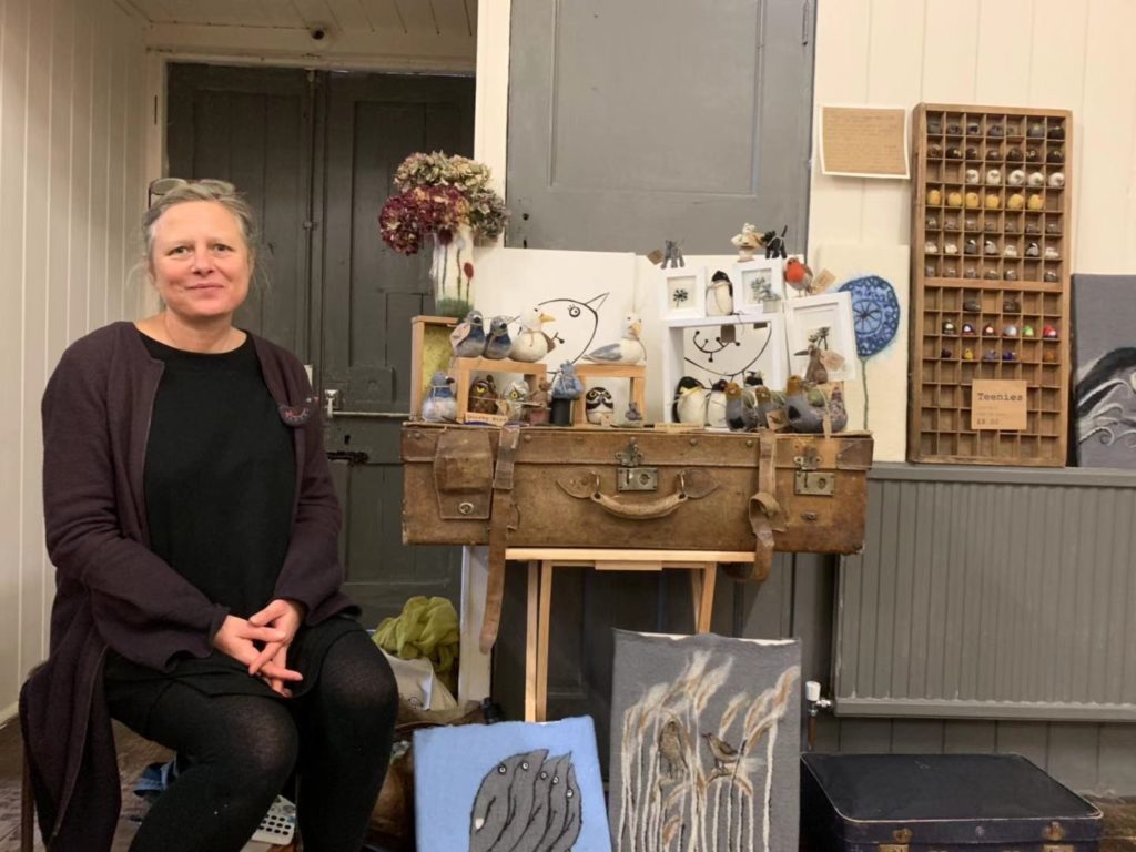 Ruth Packham sitting next to her animal friends