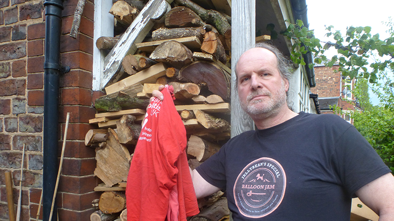 man standing with red t-shirt - laundry item