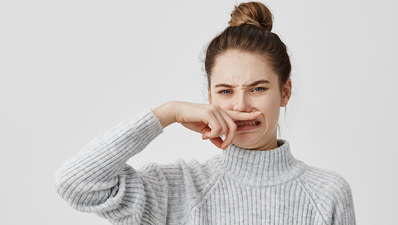 woman with finger on nose