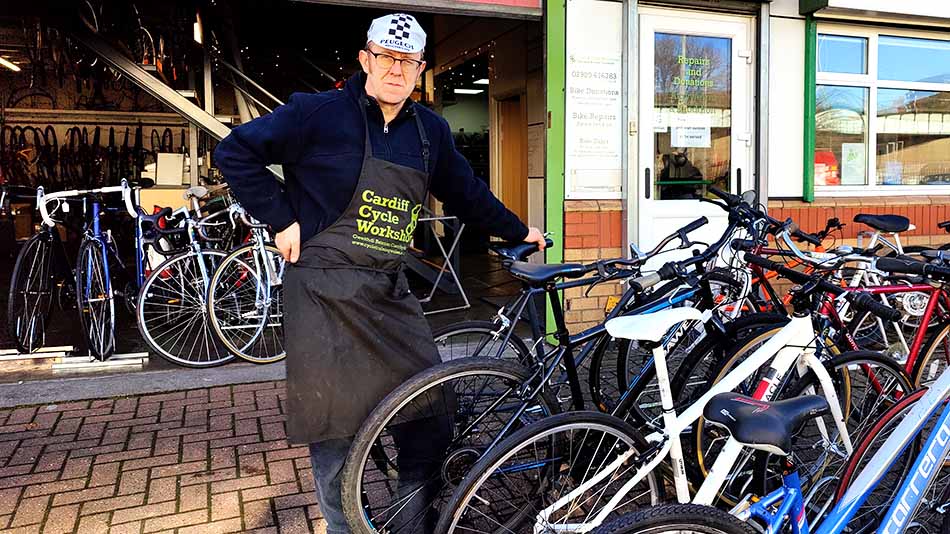 Andrew Burns next to bicycles at a sale