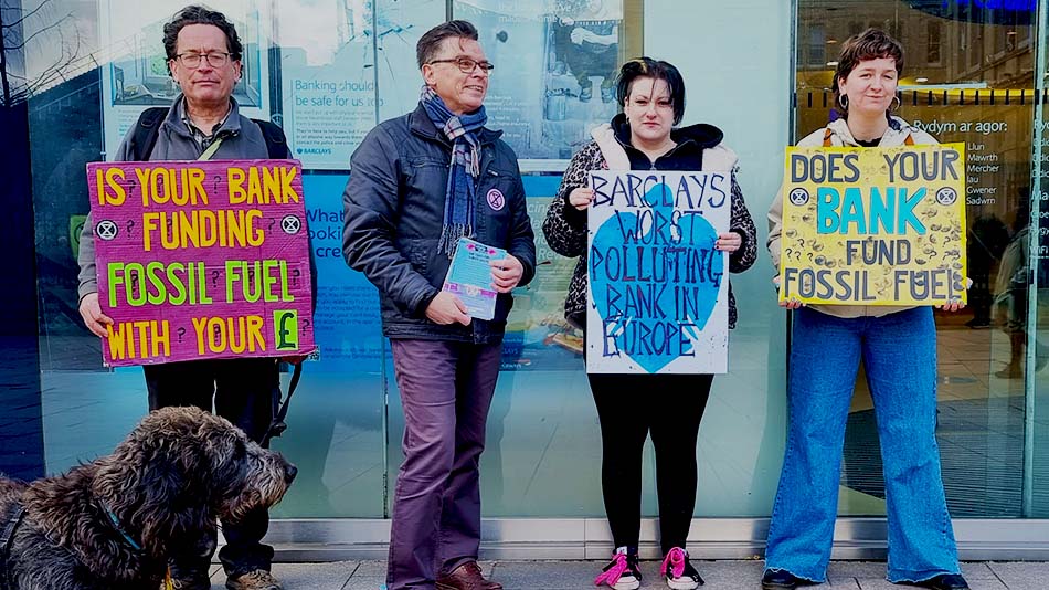 Four protestors holding different placards