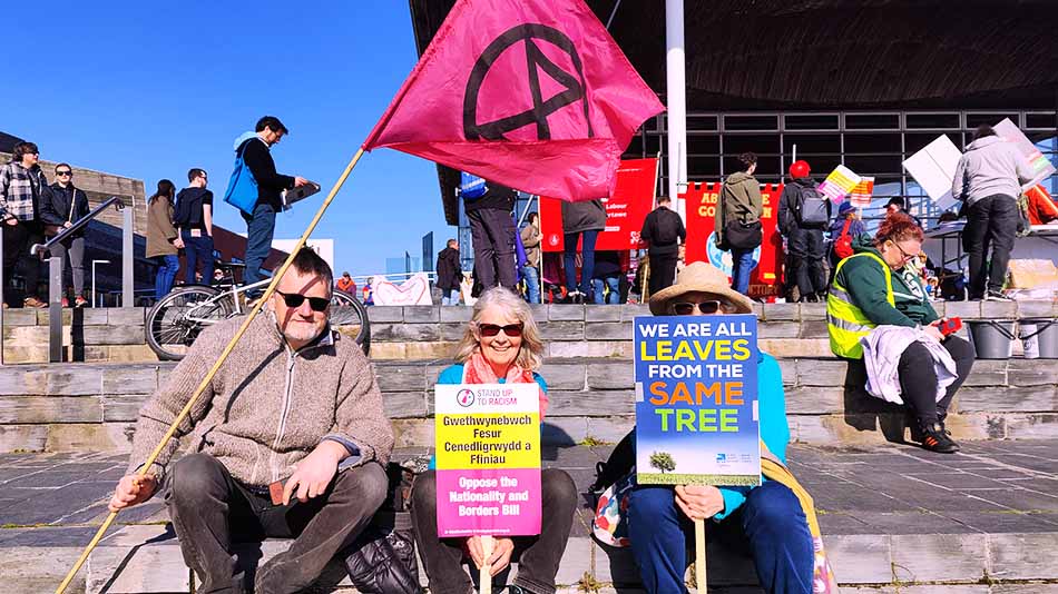 Extinction Rebellion activists holding a flag and placards