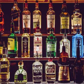 A bar shelf with bottles of spirit