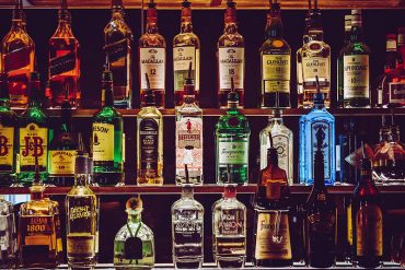 A bar shelf with bottles of spirit