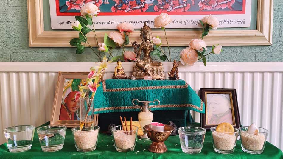 An idol of Green Tara with offerings