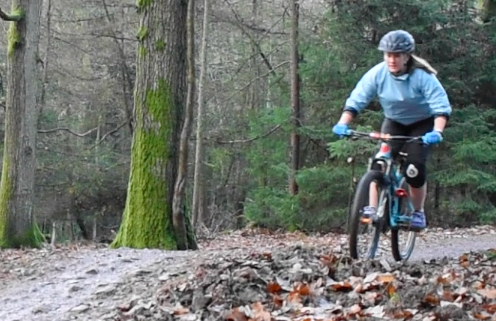 Laura riding down a trail at the Forest of Dean. 