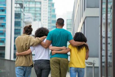 FOUR PEOPLE HANDS ARMS IN ARMS