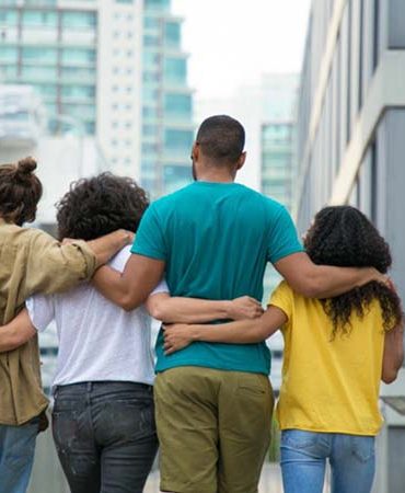 FOUR PEOPLE HANDS ARMS IN ARMS