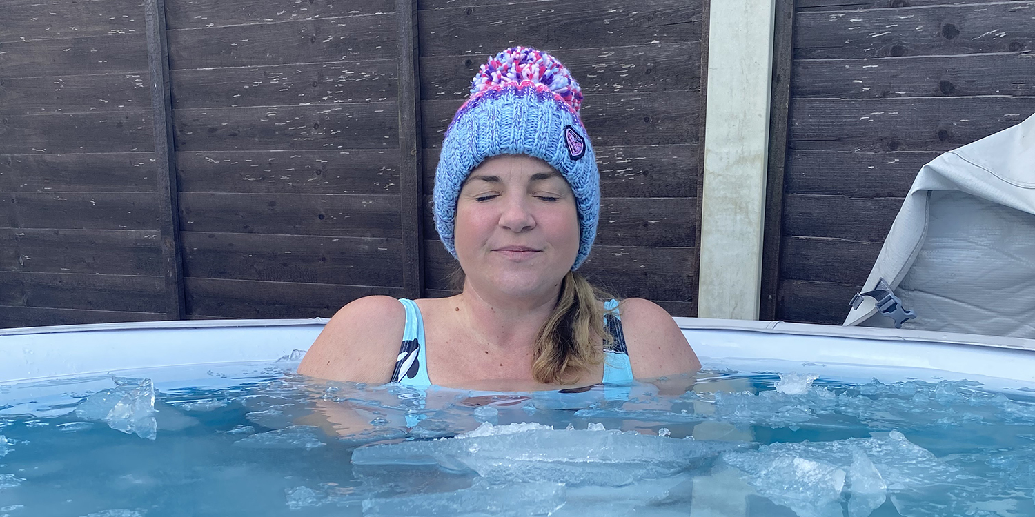 Frequent cold-water swimmer, Kerry Dawson, sits in a cold-water pool in the garden