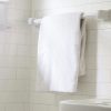 A picture of white towels hanging in a bathroom