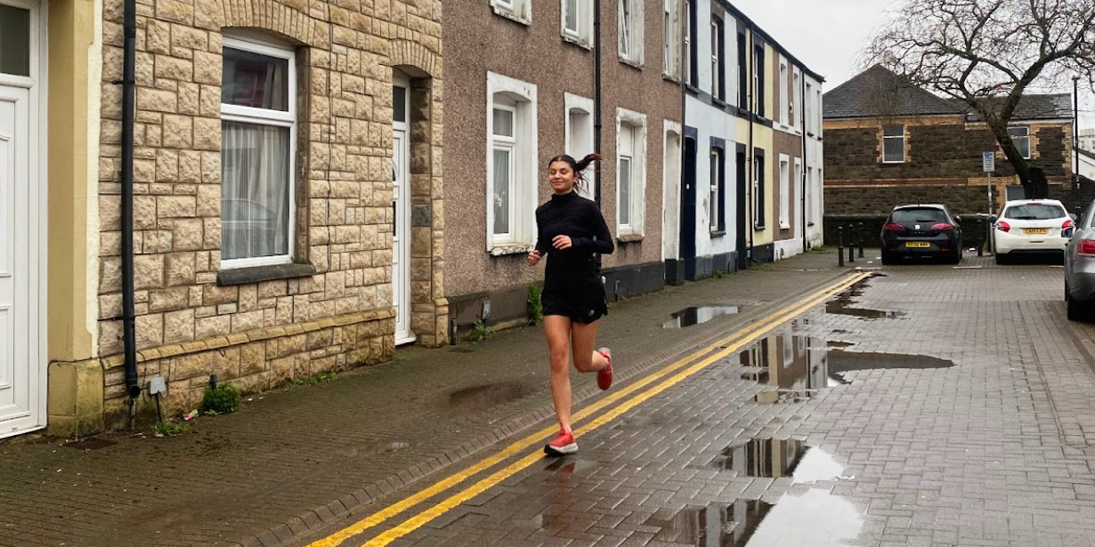 Our social media editor dressed in black running gear runs down a street in Cardiff