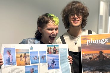 Two people holding Plunge issue one