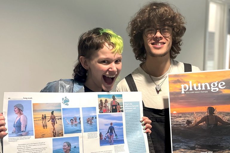 Two people holding Plunge issue one