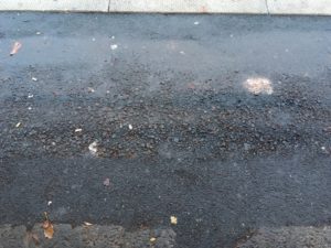The rough pavement has not been repaired since the incident