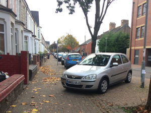 Cars parking on the footpath.