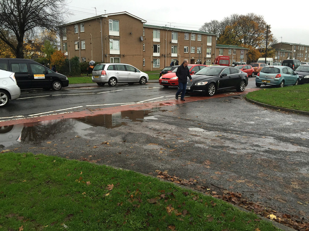 Cars parked on the white zig-zag lines outside Pwll Coch primary school.