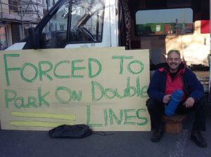 Vincent with his van during the second day of his protest. Passersby signed his placard in support.