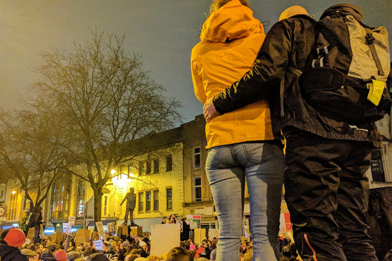 A couple overlooking the protesters on Queen Street