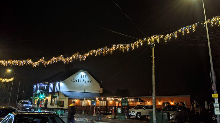 Christmas lights illuminate the streets of Llandaff North, with The Railway photographed in the background