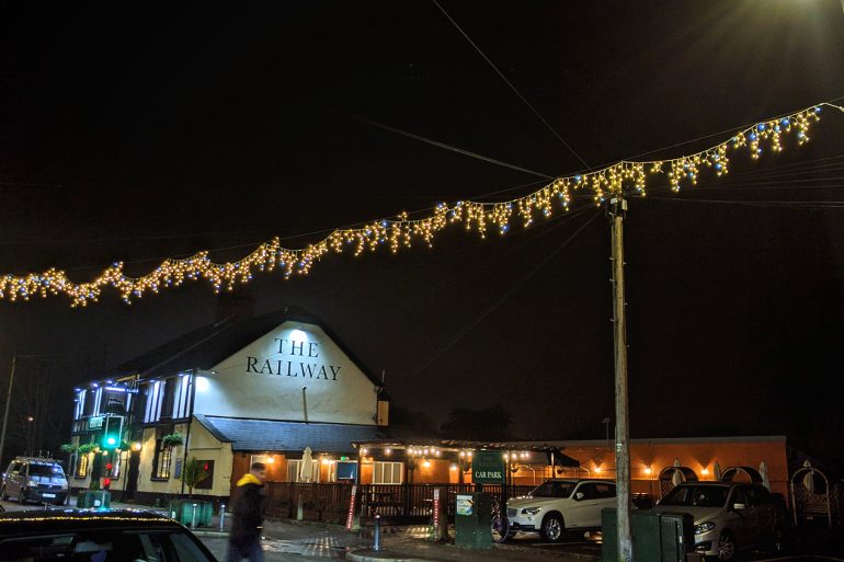 Christmas lights illuminate the streets of Llandaff North, with The Railway photographed in the background