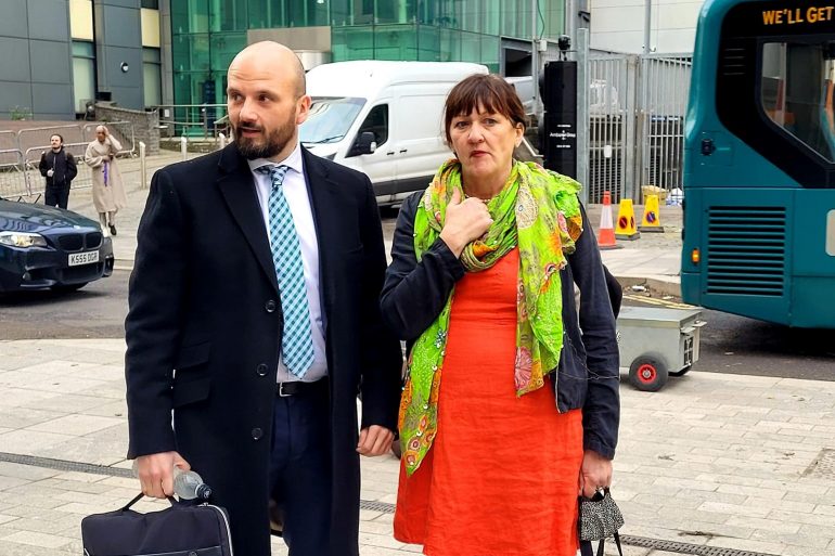 Cat Lewis stands outside the High Court in Cardiff