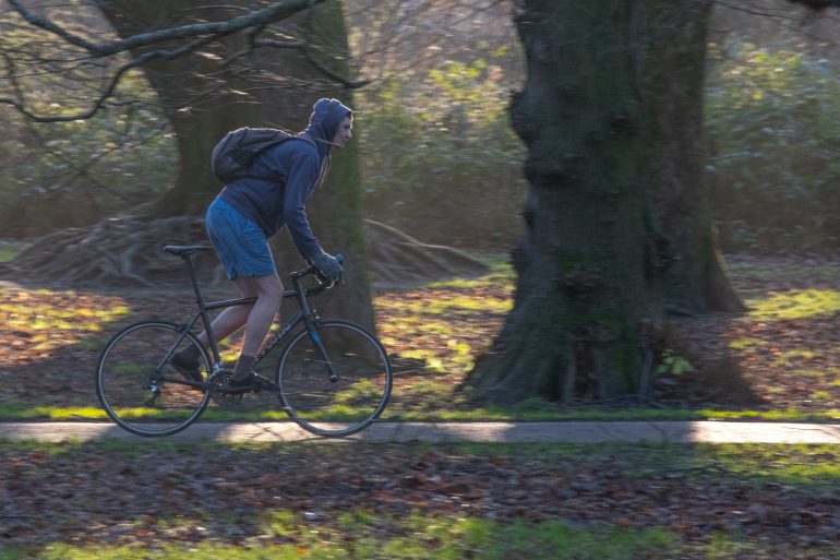 Man cycling through Bute Park