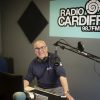 Ceri Stennett, one of Radio Cardiff's broadcasters, sitting in the studio with his radio equipment
