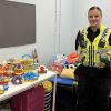 PCSO Kylie Barclay standing next to tables filled with children's toys