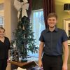 Carys and Mason from Coopers Carvery stand next to their gift tree.