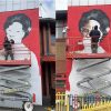 Bradley Rmer working on the Betty Campbell mural in Butetown. Credit: Mount Stuart Primary School