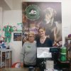 two women standing behind a shop counter