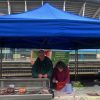 John Thomas behind a stall at Riverside Market.