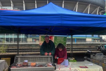 John Thomas behind a stall at Riverside Market.