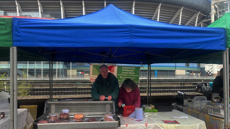 John Thomas behind a stall at Riverside Market.