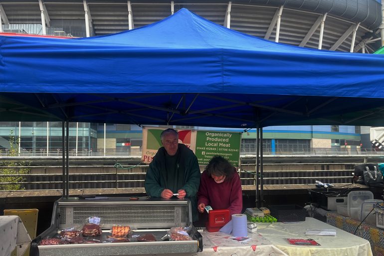 John Thomas behind a stall at Riverside Market.