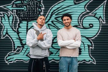 Suliman Khan (Left) standing outside the ICE store in Grangetown with a regular client (Right). Credit: Ice Cream Embroidery