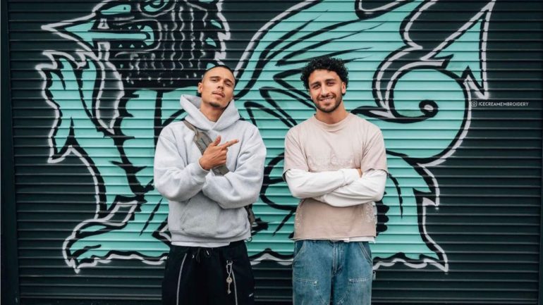 Suliman Khan (Left) standing outside the ICE store in Grangetown with a regular client (Right). Credit: Ice Cream Embroidery