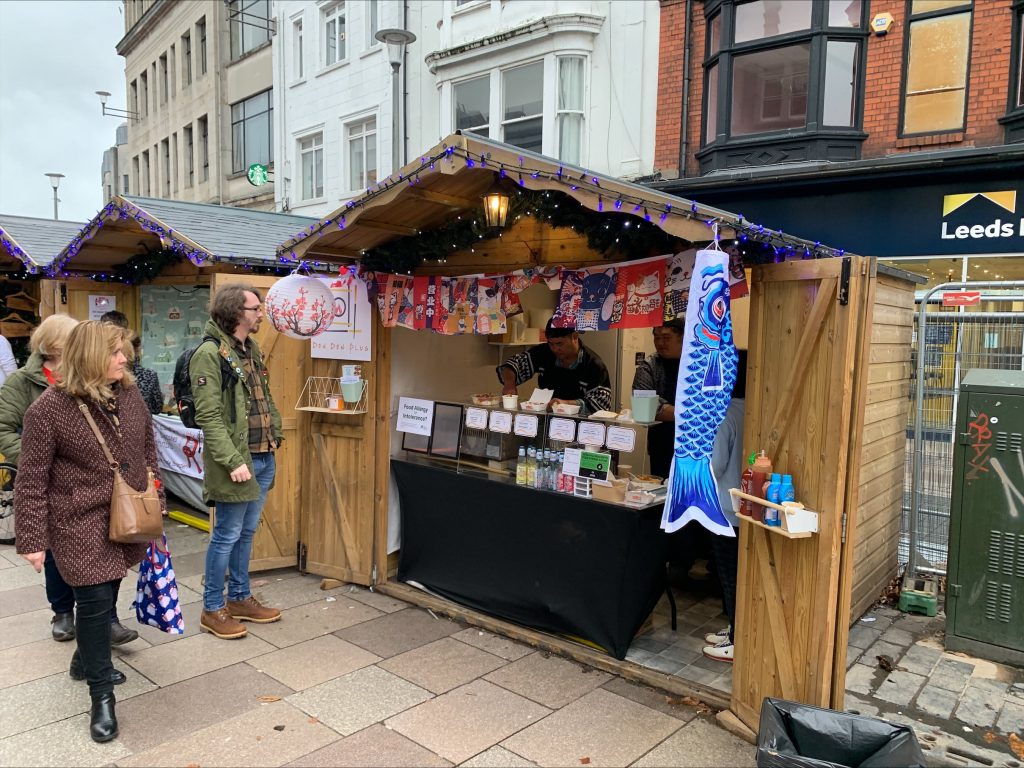 David Chan of Don Don Yatai serves food to customers at Cardiff Christmas Market